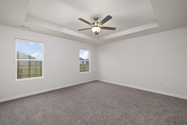 1756 Cash Dr, Mount Vernon, MO 65712 - spare room with visible vents, baseboards, a tray ceiling, and carpet floors