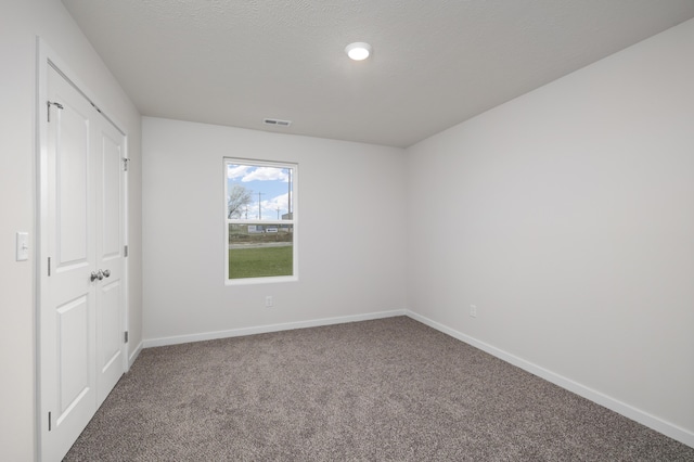 1756 Cash Dr, Mount Vernon, MO 65712 - unfurnished bedroom with visible vents, baseboards, carpet, and a textured ceiling