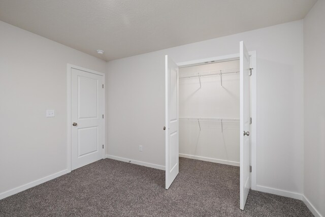 1756 Cash Dr, Mount Vernon, MO 65712 - unfurnished bedroom featuring a closet, baseboards, and carpet