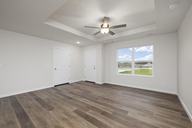 1756 Cash Dr, Mount Vernon, MO 65712 - unfurnished room featuring visible vents, a raised ceiling, baseboards, and dark wood-style flooring