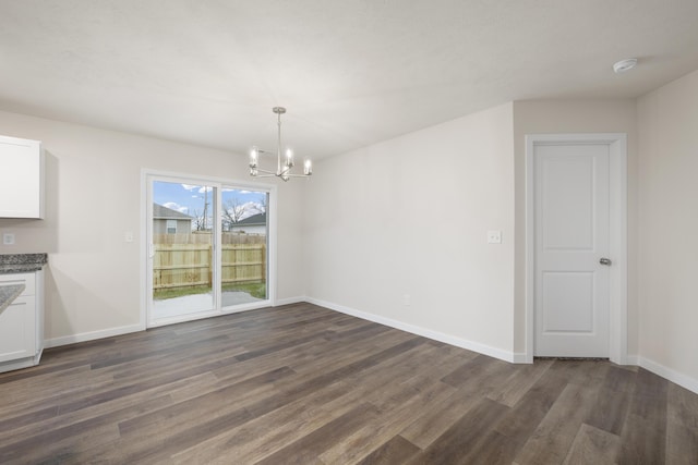 1756 Cash Dr, Mount Vernon, MO 65712 - unfurnished dining area featuring baseboards, a notable chandelier, and dark wood-style flooring