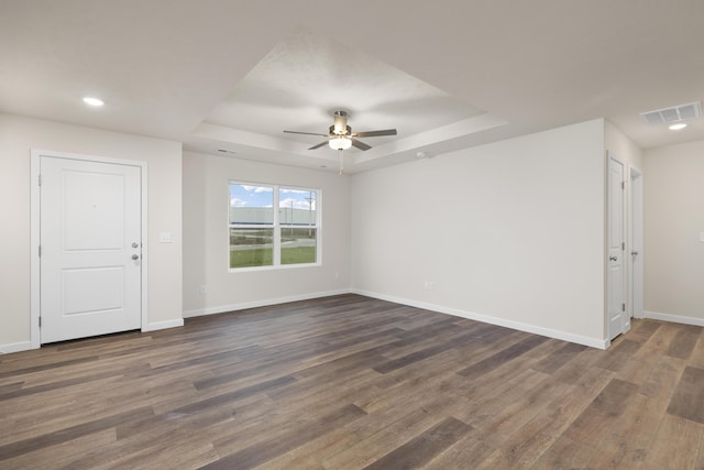 1756 Cash Dr, Mount Vernon, MO 65712 - unfurnished room with dark wood-style floors, visible vents, a raised ceiling, and baseboards