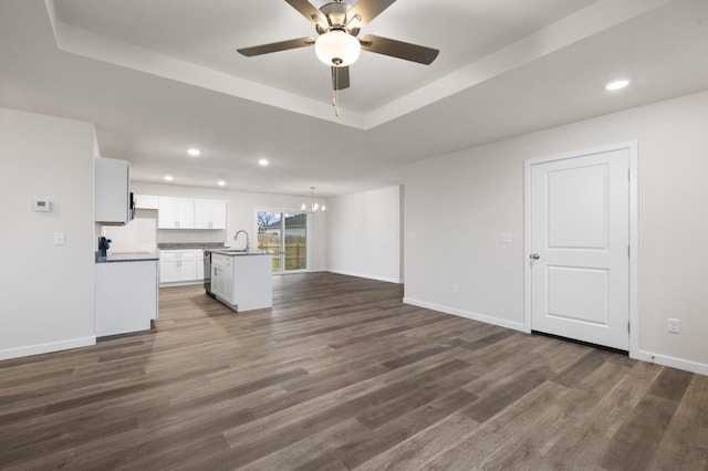 1756 Cash Dr, Mount Vernon, MO 65712 - unfurnished living room with dark wood-style flooring, a raised ceiling, baseboards, and a sink