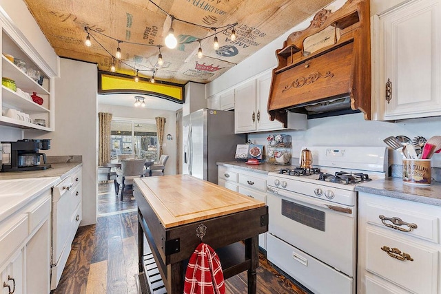 kitchen featuring stainless steel fridge, white range with gas stovetop, white cabinetry, and dark wood-style flooring