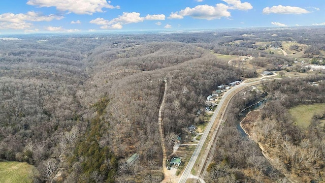 aerial view featuring a wooded view