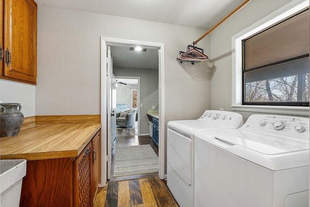 clothes washing area featuring cabinet space, dark wood-style floors, and independent washer and dryer