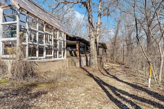 exterior space featuring a greenhouse and an outdoor structure