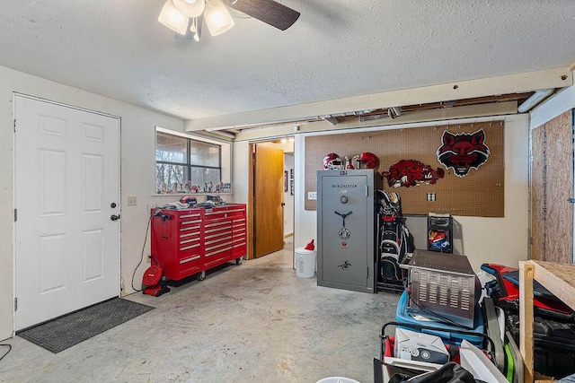 garage with ceiling fan and a workshop area