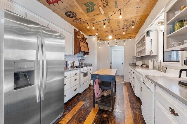 kitchen with white appliances, dark wood-style flooring, a sink, white cabinetry, and open shelves