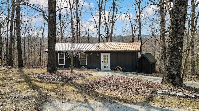 view of front of home with metal roof and board and batten siding