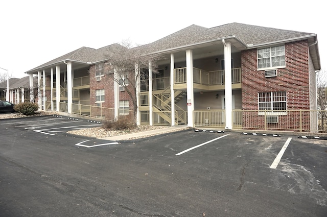 view of building exterior featuring uncovered parking