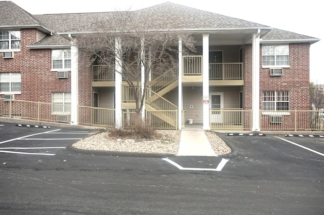 view of property featuring uncovered parking