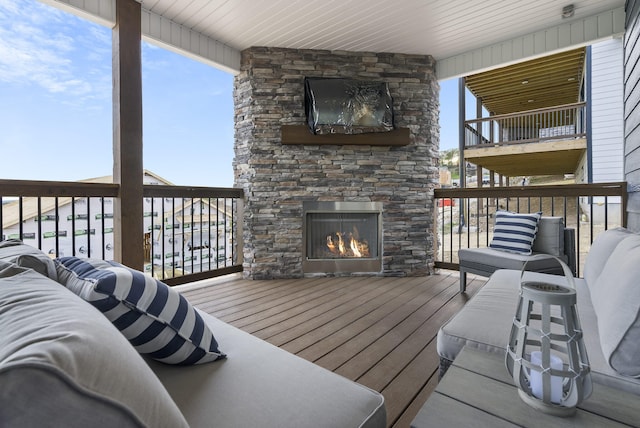 wooden deck featuring an outdoor living space with a fireplace