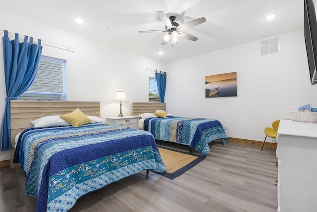 bedroom featuring recessed lighting, visible vents, baseboards, and wood finished floors