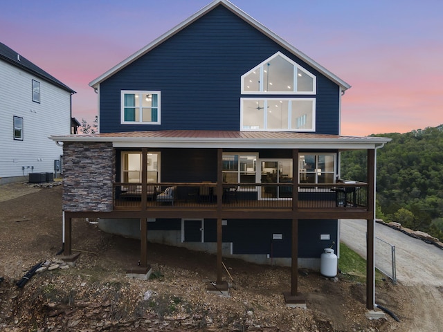 rear view of property featuring central air condition unit