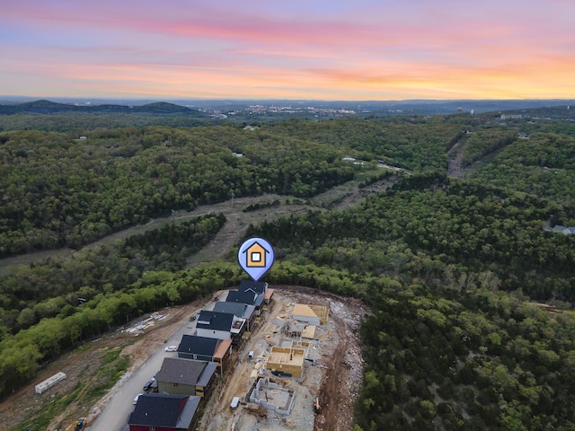 bird's eye view featuring a wooded view