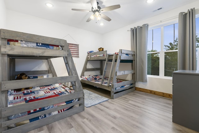 bedroom featuring wood finished floors, visible vents, and recessed lighting