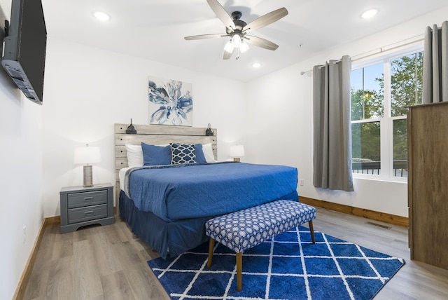 bedroom featuring baseboards, visible vents, wood finished floors, and recessed lighting