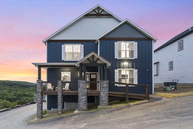 view of front of property with board and batten siding and cooling unit