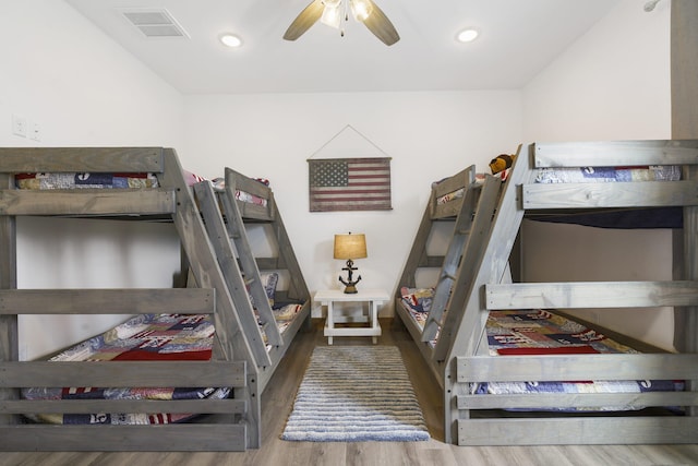 bedroom with recessed lighting, visible vents, and wood finished floors