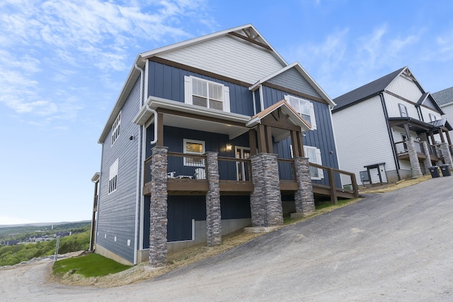 view of front of house featuring board and batten siding and a balcony