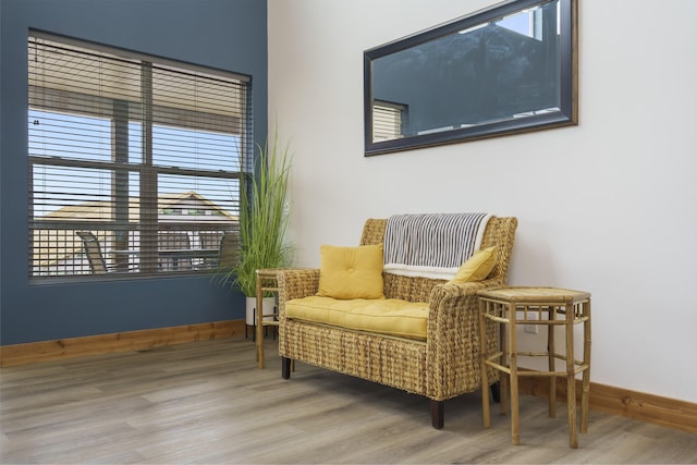 sitting room with baseboards and wood finished floors