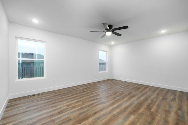 empty room featuring baseboards, visible vents, dark wood-style floors, ceiling fan, and recessed lighting