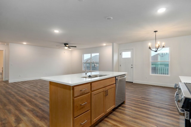 kitchen with stainless steel appliances, light countertops, a sink, and dark wood-style floors