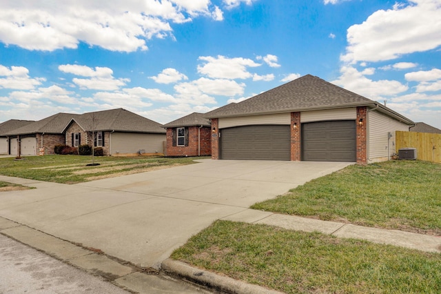 ranch-style house featuring brick siding, a front yard, central AC, a garage, and driveway