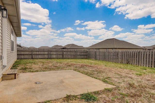 view of yard with a patio area and a fenced backyard