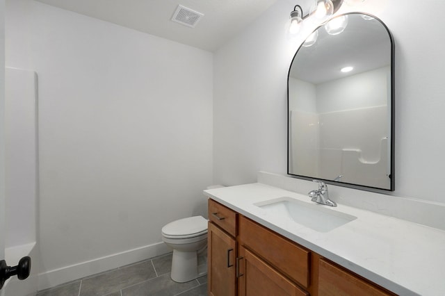 bathroom featuring baseboards, visible vents, toilet, tile patterned floors, and vanity