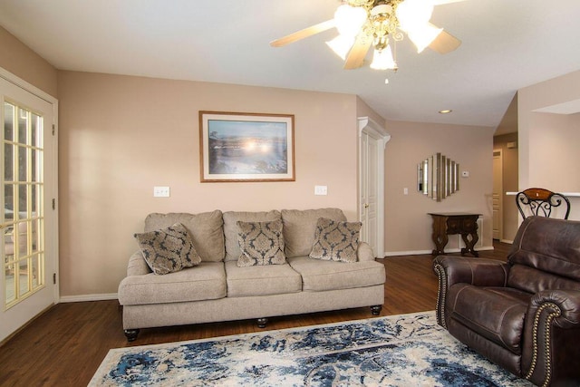 living room with dark wood finished floors, baseboards, and ceiling fan