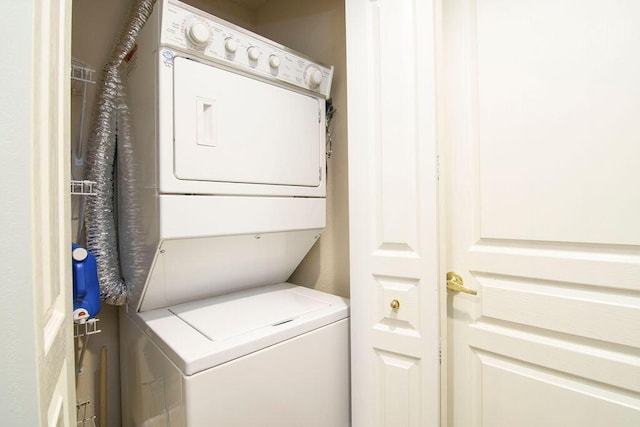 washroom with laundry area and stacked washer / drying machine