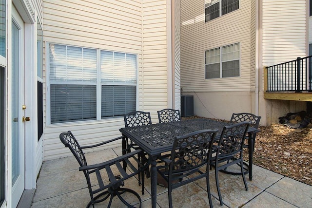 view of patio with outdoor dining space and cooling unit