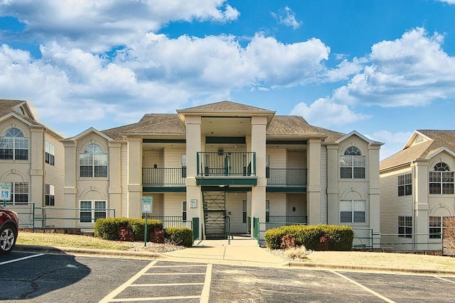 view of building exterior with uncovered parking