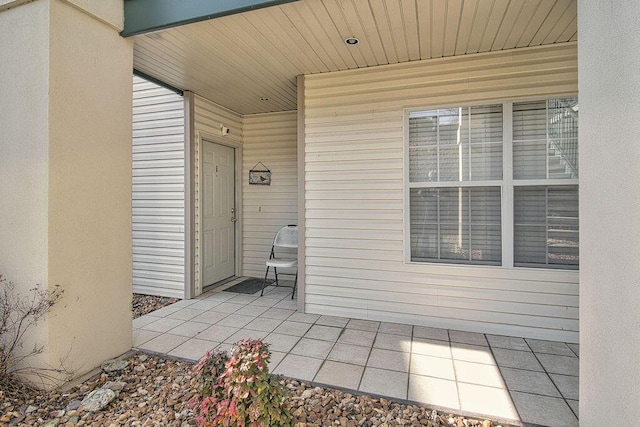 doorway to property featuring a patio area and stucco siding