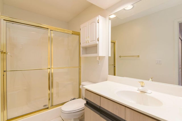full bathroom with toilet, a shower stall, and vanity