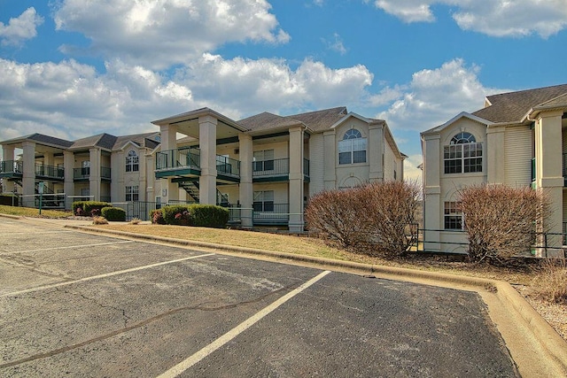 view of building exterior with uncovered parking