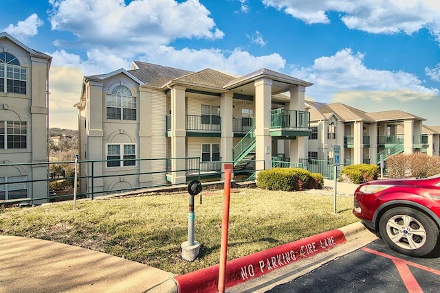 view of property with a residential view, fence, and uncovered parking