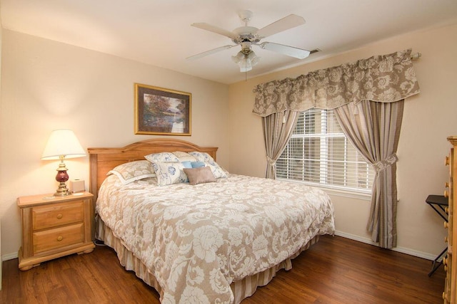 bedroom featuring ceiling fan, wood finished floors, and baseboards