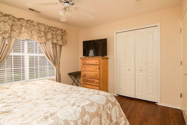 bedroom featuring a closet, visible vents, ceiling fan, wood finished floors, and baseboards