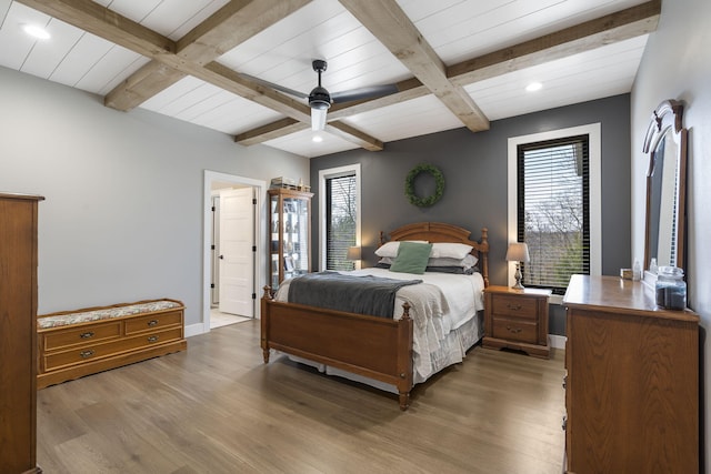 bedroom with beam ceiling, a ceiling fan, light wood-style flooring, and baseboards