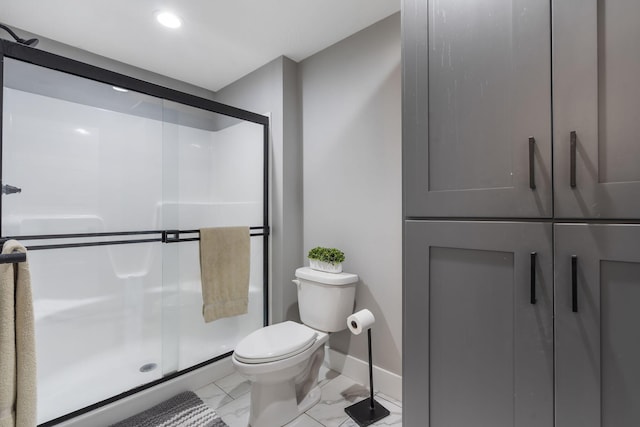 full bathroom with a stall shower, marble finish floor, baseboards, and toilet