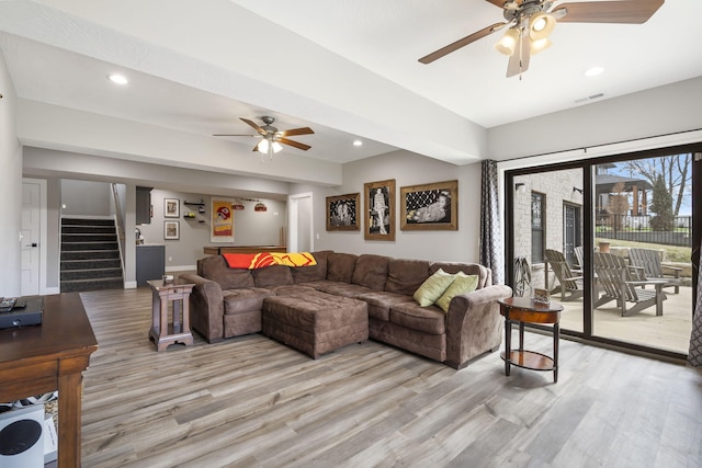 living room with light wood finished floors, recessed lighting, visible vents, a ceiling fan, and stairs