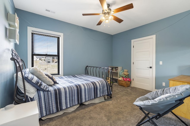 carpeted bedroom featuring visible vents and a ceiling fan