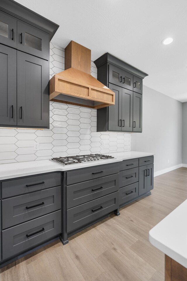 767 Thornridge Dr, Springfield, MO 65809 - kitchen with stainless steel gas stovetop, gray cabinetry, custom range hood, backsplash, and recessed lighting
