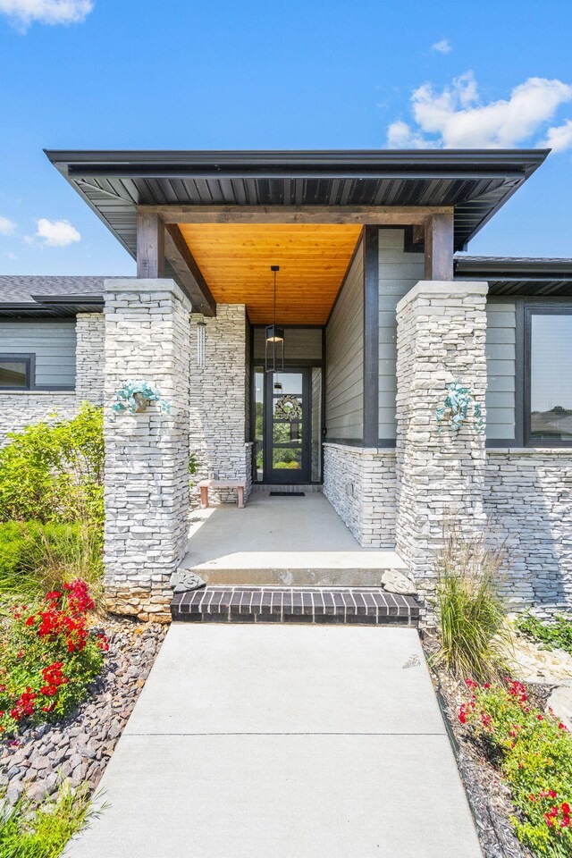 767 Thornridge Dr, Springfield, MO 65809 - doorway to property featuring stone siding and covered porch
