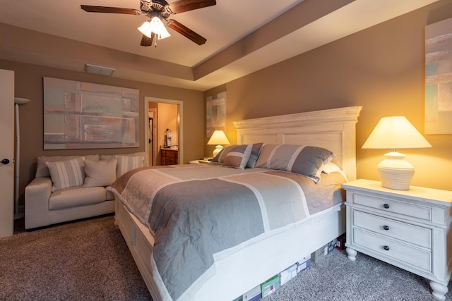 bedroom with ensuite bathroom, carpet floors, ceiling fan, and visible vents