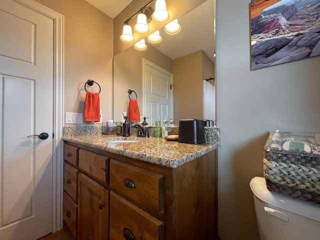 bathroom with toilet and vanity