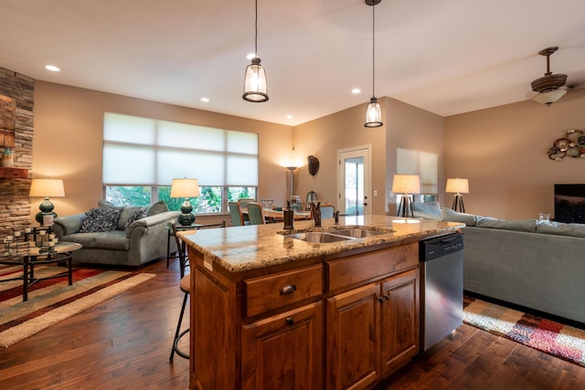 kitchen featuring a sink, dark wood-style flooring, open floor plan, and dishwasher